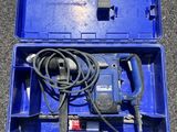a blue box with a drill and a cord in it