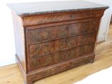 a wooden dresser with a marble top on a hard wood floor