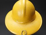 yellow fireman ' s hat on a black background