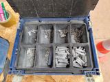 a tool box filled with screws and nails on a table