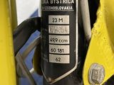 a close up of a yellow motorcycle with a black and white label