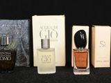 many different perfumes on a table with a clock in the background