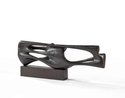 sculpture of a hand holding a gun on a wooden base