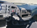 a dashboard of a vehicle with a steering wheel and dashboard controls