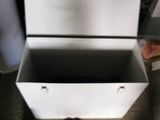 a white box with a lid sitting on the floor