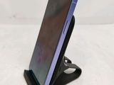 the phone is sitting on top of the stand on the table