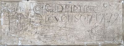 a stone plaque with writing on it on a wall