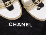 a pair of chanel shoes on a black and white bag