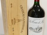 a bottle of wine sitting next to a wooden box