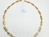 a gold and silver necklace on a white background