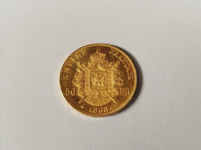 a close up of a gold coin on a white surface