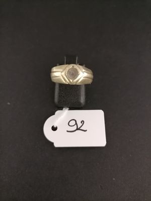 a close up of a ring with a price tag on a table