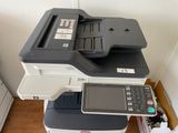 a multi - function printer sitting on top of a box