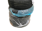four tires stacked on top of each other on a white surface