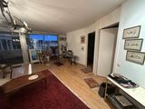 a living room with hardwood floors and a large window