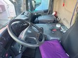 a steering wheel of a truck with a purple blanket on it