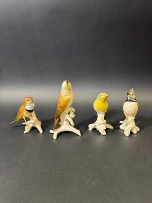 five figurines of birds sitting on top of each other