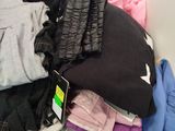 a pile of clothes sitting on a shelf in a closet