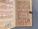 an open book with stamps on it on a table