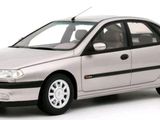 a silver car that is parked on a white surface
