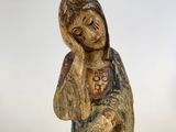 an old statue of a woman holding a baby in her arms