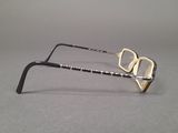 a pair of glasses on a table with a gray background
