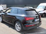 a black audi suv parked in a parking lot