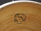 a close up of a wooden bowl with a smiley face on it