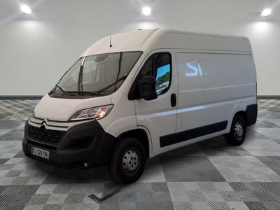 the white van is parked on a checkered floor in a room