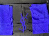 a close up of a pair of blue and black pants on a couch