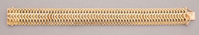 a close up of a piece of gold colored metal on a gray surface