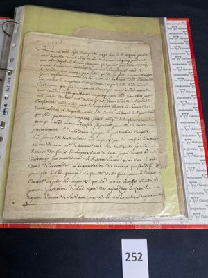 an old document with writing on it sitting on a table