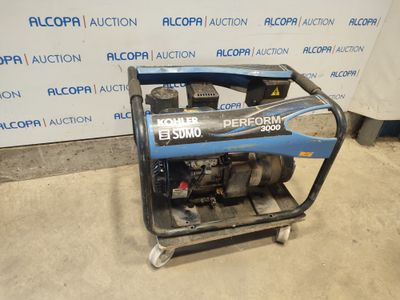 an electric generator sits on a cart in front of a wall
