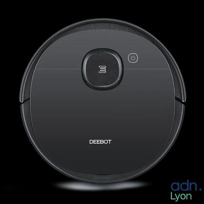 a close up of a robot vacuum cleaner on a black background