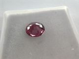 a close up of a pink diamond on a white surface