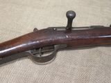 an old rifle with a wooden handle on a table
