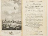 an open book with a picture of a city in the background
