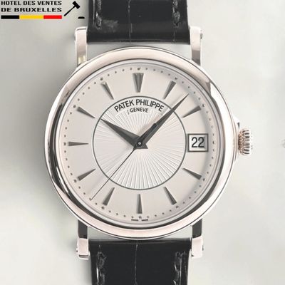 a close up of a wrist watch with a white dial