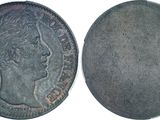 a close up of a coin on a white surface