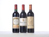 three bottles of red wine are lined up on a table