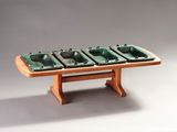 a wooden table with four green bowls on it