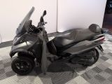 a scooter that is parked on a checkered floor