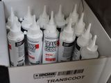 many bottles of paint in a box on the floor