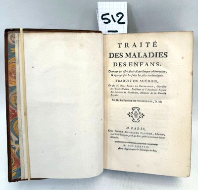 a book open on a table with a tag on it