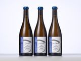 three bottles of wine sitting on top of a table next to each other