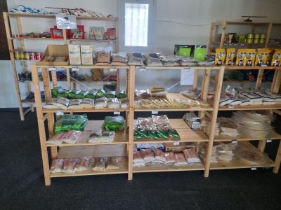 many shelves of food that are on display in the room