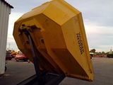a large yellow dumper sitting in a parking lot