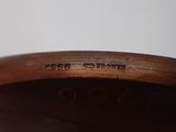 a close up of a wooden bowl on a table with a white background