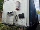 two semi trucks that are parked on the side of the road