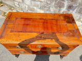 an old wooden chest of drawers with a shadow of a horse on it